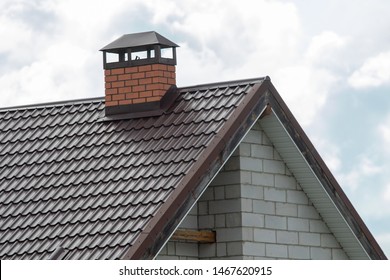 The roof of the house against the sky. New brick house tile.