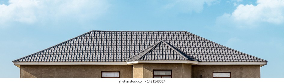 The roof of the house of the metal profile against the sky - Shutterstock ID 1421148587
