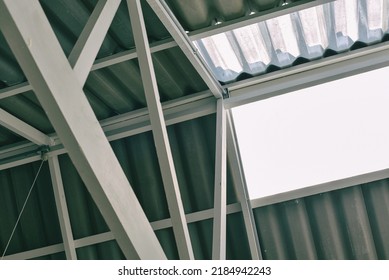 Roof metal structure, Transparent acrylic roof, Factory or warehouse natural lighting construction for energy saving. - Shutterstock ID 2184942243