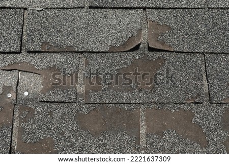 Roof in need of repair damaged asphalt roofing shingles architecture construction background texture pattern abstract concept