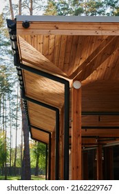 The Roof Of An Open Veranda Made Of Wood Trim With Plastic Pipes For Rain Gutters, An Element Of Architecture