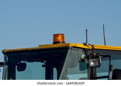 The Roof Of The Operators Cab Of A Yellow Backhoe