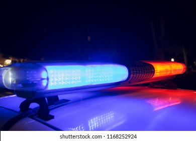 Roof Of Police Car At Night, Lights Flashing
