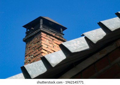 The Roof Of A Private House With A Square Brick Chimney