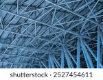 Roof of production facility, view from inside. Hangar ceiling with lighting fixtures. Factory building made of metal structures. Industrial architectural structure. Exhibition center ceiling