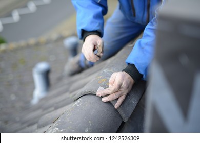 Roof Repair After Storm Damage, Roofer Worker On The Roof Showing 2 Worker Hands Nailing A Clip