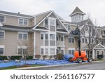 roof repair of apartment building, construction site with crane     