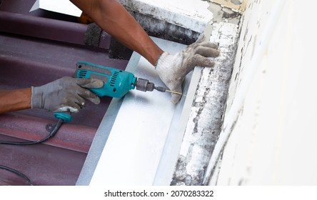 Roof repair, Worker with steel sheet. Stop a roof leak
