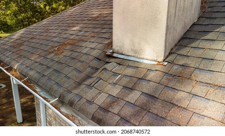 Roof and shingles damaged from water leak - Shutterstock ID 2068740572