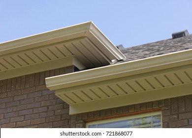 Roof showing gutters and soffit on the back of a brick house.