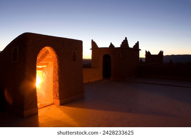 Roof terrace at dawn on a kasbah in the town of nkob, with light glowing from the staircase, nkob, morocco, north africa, africa - Powered by Shutterstock