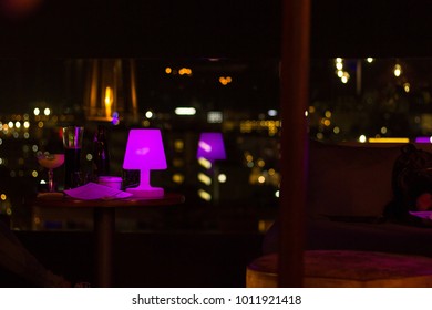 Roof Terrace Nightclub. Purple Table Lamp Of Lounge Decoration. Bokeh Effect Reflection. Party Ambiance