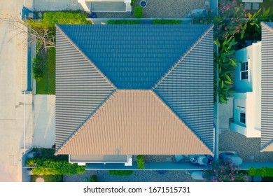 Roof And Roof Tile Pattern Or Texture. Cover On Top Of Home Building In Top, Above Or Aerial View. Made From Fiber Cement. Clean, New And Dark Brown Color. Include Green Plant In Garden And Fence.