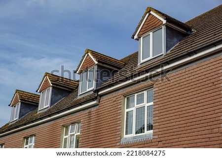 roof top of residential building with hip roof dormer windows. rental flats in city ストックフォト © 