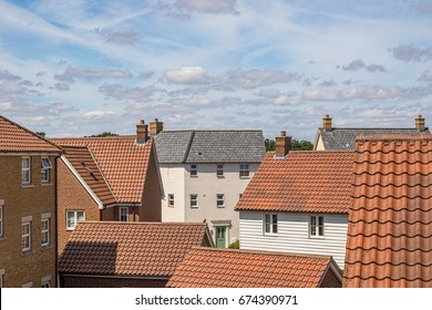 Roof Top View Of Modern Urban Housing Estate. Bright Cloudy Day Over New Varied Homes On Crowded Suburban Residential Area.