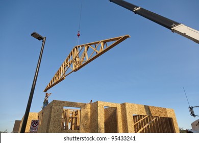 Roof Trusses Being Hoisted Onto Roof