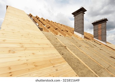 Roof Under Construction.Installation Mineral Wool Insulation. 