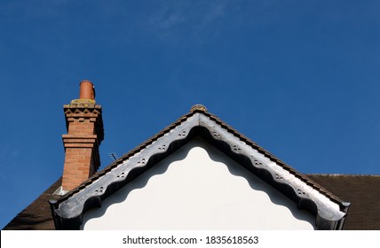 Roof Of Victorian House With Soffits And Ornate Brick Built Chimney