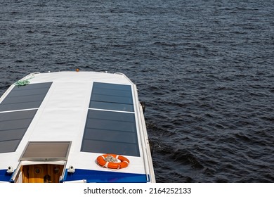 The Roof Of A White Passenger Boat With Large Windows On The Background Of Water. Space For Printing Text.