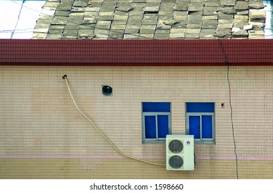 Roof, Window, And AC Unit With Run-down Tiles.