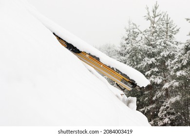 Roof window under a large layer of snow
