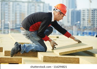 Roofer Builder Worker Installing Roof Insulation Material