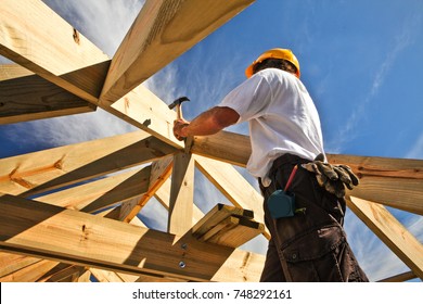 Roofer, Carpenter Working On Roof Structure On Construction Site