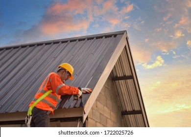 Roofer Construction Worker Install New Roof,Roofing Tools,Electric Drill Used On New Roofs With Metal Sheet.