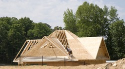 A roofer finishing the decking of a new roof, an Industrial Photo by Darryl Brooks