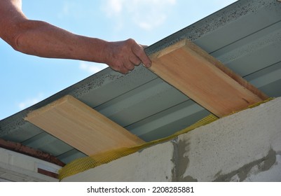 Roofer Installing Lightweight Metal Roofing Sheets On New House Rooftop. Lightweight Metal Roofing Construction.