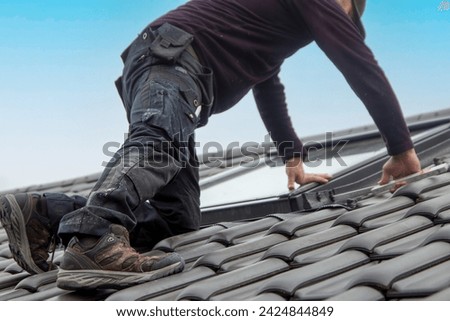 Roofer installing a new roof window