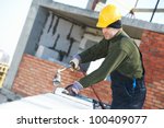 Roofer installing Roofing felt with heating and melting roll of bitumen roll by torch on flame