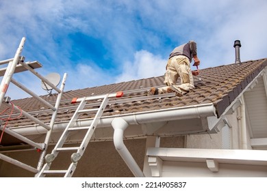 Roofer, Worker On The Rooftop. Roofing Work. Solar Cell Installation. Preparation Of Solar Panel Installation. Attaching Rails. Scaffolding On Construction Site