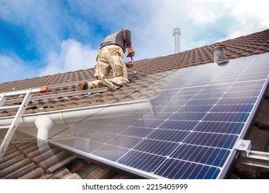 Roofer, Worker On The Rooftop. Roofing Work. Solar Cell Installation. Preparation Of Solar Panel Installation. Attaching Rails. Scaffolding On Construction Site