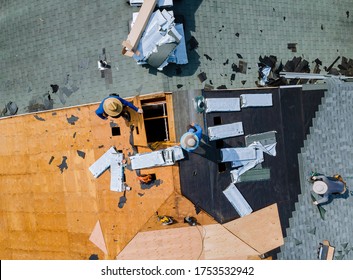 Roofer Working On Replacement Asphalt Shingle Roof Construction