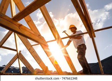 roofer,carpenter working on roof structure on construction site