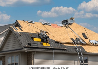 Roofers completely replace old asphalt shingle roof during summer in Canada