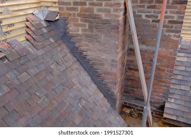 Roofing Construction With Clay Tiles And Lead Step Flashing Up Chimney