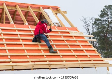 Roofing contractor installing roof boards and vapor barriers in winter time. - Shutterstock ID 1935709636