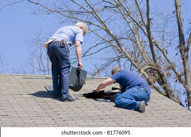 Roofing Contractor Repairing Damaged Roof On Home After Recent Wind Storms, Many Roofs Were Damaged