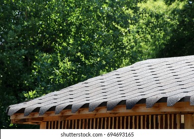 Roofing Flexible Fiberglass Asphalt Shingles On A Modern Pavilion Roof In The Summer Garden