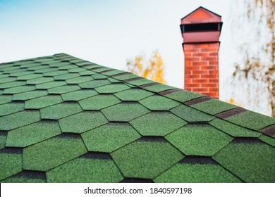 Roofing Made Of Soft Bitumen Tiles Of Green Color On The Hipped Roof Of A Country House