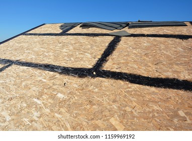 Roofing preparation asphalt shingles installing on house construction wooden roof with bitumen spray. Roofing construction. Installing bitumen roof shingle. - Shutterstock ID 1159969192