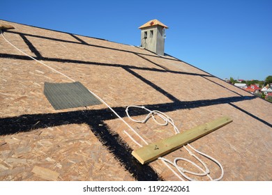 Roofing preparation asphalt shingles installing on house construction wooden roof with bitumen spray and  protection rope, safety kit. Roofing construction.  - Shutterstock ID 1192242061