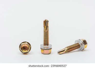 roofing screws on a white background. photo of self-tapping screws for the catalog on a light background. set of bolts for working with metal tiles and iron