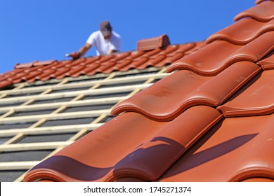 Roofing work, new covering of a tiled roof - Shutterstock ID 1745271374