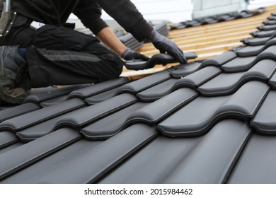 Roofing work, new covering of a tiled roof - Shutterstock ID 2015984462