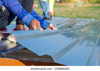 
Roofing Workers Used Metal Sheets On The Roof Of The House.