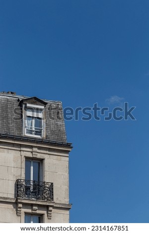 Roofs of houses close-up with space for text against the blue sky.