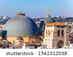 The roofs of Jerusalem. Domes of the Temple of the Holy Sepulcher. Golden crosses sparkle in the sunset. Bird